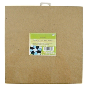 May include: A brown cardboard stained glass work surface, ideal for cutting and assembling stained glass projects. The packaging features a small image of a stained glass design and the text "Studio Pro" and "Stained Glass Work Surface".