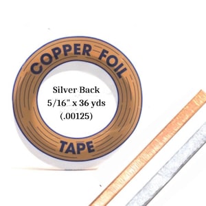 May include: Copper foil tape with a silver back. The tape is 5/16 inch wide and 36 yards long. The tape is labeled "Copper Foil Tape" and "Silver Back".