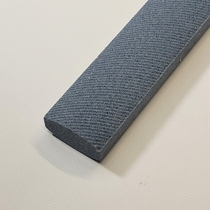 May include: A gray rectangular sharpening steel with a textured surface.