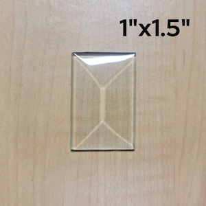 May include: A clear glass tile with a diamond pattern, measuring 1 inch by 1.5 inches.