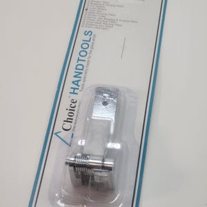 May include: A silver-colored glass cutter tool with a spring mechanism. The tool is packaged in a clear plastic blister pack with a white backing card that reads "Choice HANDTOOLS" and "Tools specially made for the glass artist".