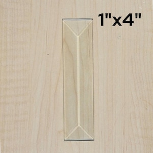 May include: A clear, rectangular acrylic sign holder, measuring 1" x 4", is displayed against a light wood grain background. The holder has a folded bottom and a thin, silver-colored trim.