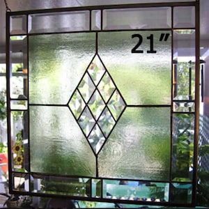 May include: A stained glass window with a diamond pattern in the center. The window is 21 inches wide.