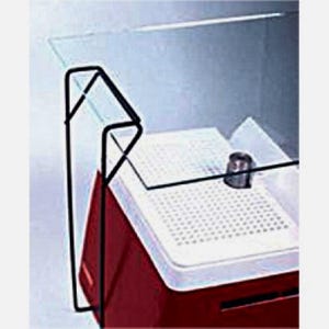 May include: A red and black plastic box with a white tray inside. The box has a clear glass lid with a black metal frame. The lid is slightly open, revealing the white tray.