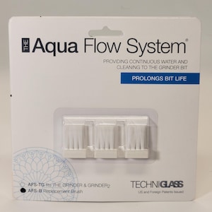 May include: Package of three white replacement brushes for The Aqua Flow System grinder. The package includes the text "The Aqua Flow System", "Providing continuous water and cleaning to the grinder bit", "Prolongs bit life", "AFS-TG fits The Grinder & Grinder2", "AFS-B Replacement Brush", "Techniglass", and "US and Foreign Patents Issued".