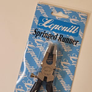 May include: A silver sprung runner pliers with black handles. The packaging is blue and white with the text "Leponitt Sprung Runner" printed on it.