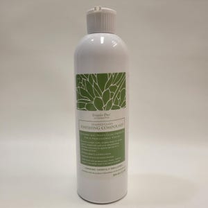 May include: White bottle of Studio Pro Stained Glass Finishing Compound. The label features green botanical art and product details. The bottle has a white cap and contains 12 fl oz of product.
