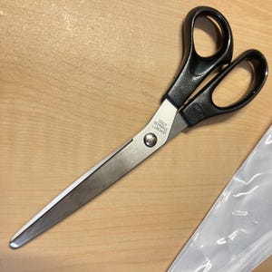 May include: Black handled scissors with silver blades. The blades are labeled "LEPOINTE STAINLESS STEEL".