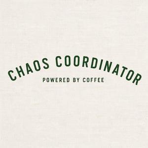 May include: A cream-colored background with the text "CHAOS COORDINATOR" in dark green, arched above "POWERED BY COFFEE" in a smaller font. The text is centered.