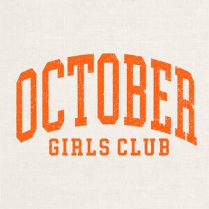 May include: A graphic design featuring the text OCTOBER GIRLS CLUB in a bold, orange, distressed collegiate font. The word OCTOBER is arched across the top, while the words GIRLS CLUB are printed in a straight line underneath on a light background.