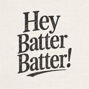 May include: Text-based design with the words "Hey Batter Batter!" in a bold, textured black font. The exclamation point adds emphasis. The background is a light beige, textured fabric.