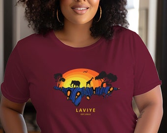 May include: Burgundy t-shirt with a sunset graphic featuring an elephant and giraffe silhouette. The design includes the text "LAVIYE EST. 2012". The shirt is a crew neck style.