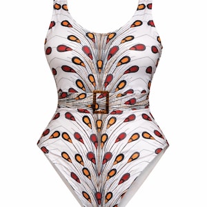 May include: White one-piece swimsuit with a colourful feather-like pattern in red, orange, and black. The swimsuit features a scoop neckline, a belt with a square buckle, and a low back. A stylish swimwear option.