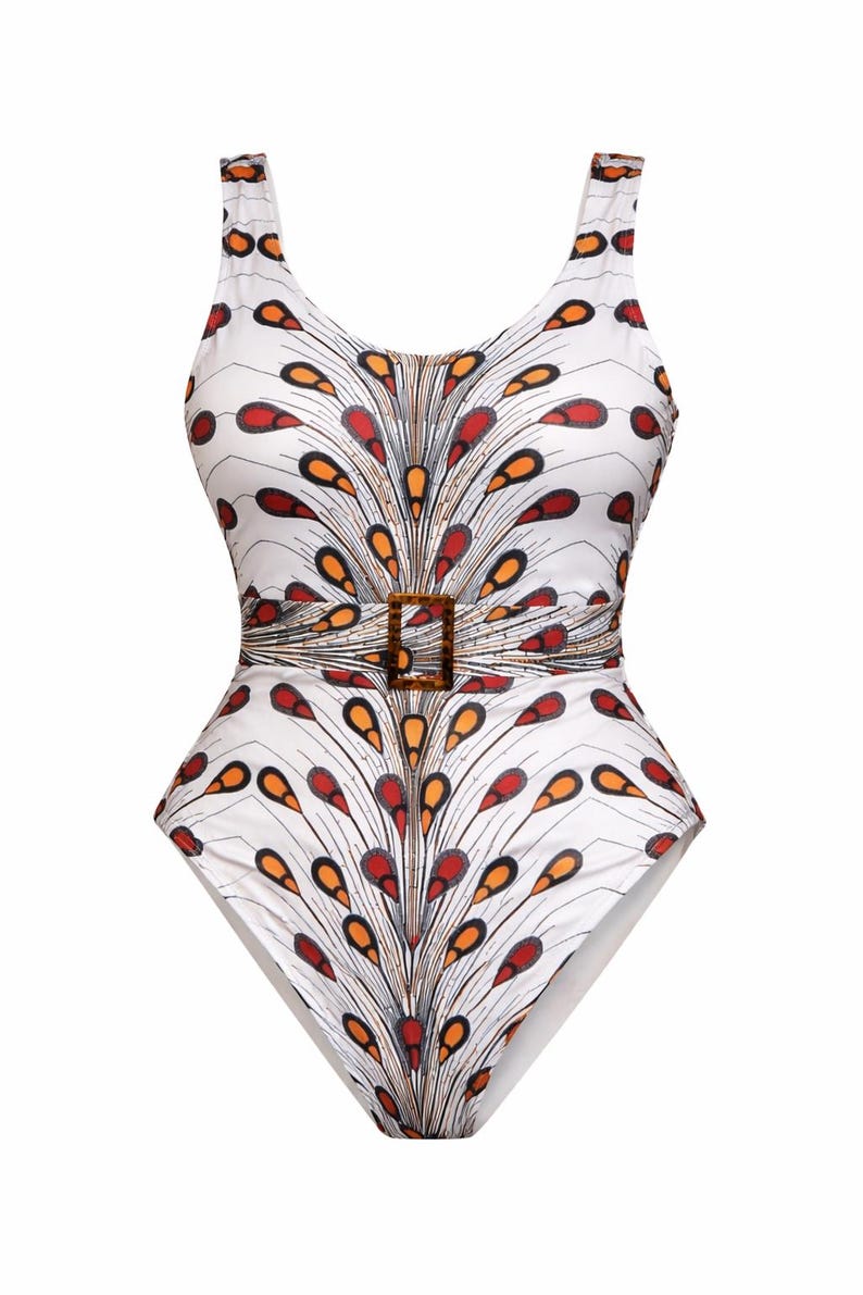 May include: White one-piece swimsuit with a colourful feather-like pattern in red, orange, and black. The swimsuit features a scoop neckline, a belt with a square buckle, and a low back. A stylish swimwear option.