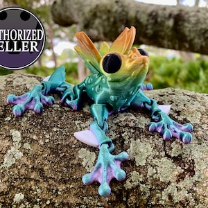 May include: A vibrant, multi-colored frog figurine with a textured, iridescent finish. The frog is posed with its legs outstretched, as if it is leaping. The figurine is made of a durable, high-quality material.