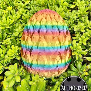 May include: A rainbow dragon egg with a textured, scaly surface. The egg is surrounded by green foliage.