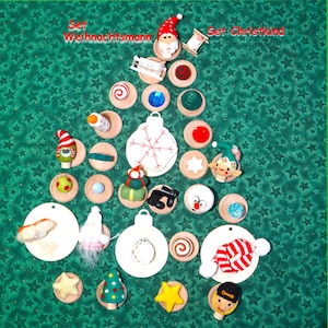 May include: A collection of Christmas ornaments and decorations arranged in a tree shape on a green star-patterned background. The ornaments include Santa Claus figures, snowmen, stars, and baubles, with the text "Set Weihnachtsmann" and "Set Christkind".