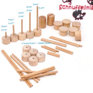 May include: A wooden toy set featuring various cylindrical and rod-shaped pieces. The set includes pieces of varying heights, with the tallest rod measuring 3.14 inches. The text "Schnuffelinis" is visible in the upper right corner.
