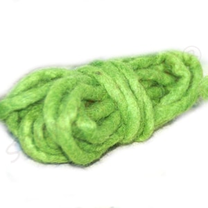 May include: A bundle of bright green yarn, tightly coiled. The yarn has a thick, textured appearance, suggesting it is made of wool or a similar fiber. The vibrant color and texture make it suitable for various crafting projects.
