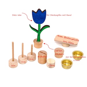 Peut inclure: Un ensemble de composants artisanaux en bois comprenant une figurine de tulipe bleue et verte, trois supports à chevilles en bois étiquetés 4cm, 3cm et 2cm, un bloc en bois fendu étiqueté Bildhalter, une base en bois de 4cm, deux disques en bois de 17mm et deux bougeoirs en laiton de 17mm.