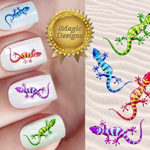 May include: Five fingernails with colourful gecko nail art designs. The geckos are in shades of blue, green, purple, red and orange.