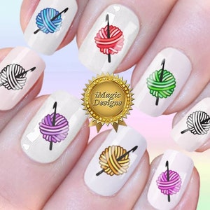 May include: Nail art stickers featuring colorful yarn balls with knitting needles. The stickers are designed to be applied to fingernails.