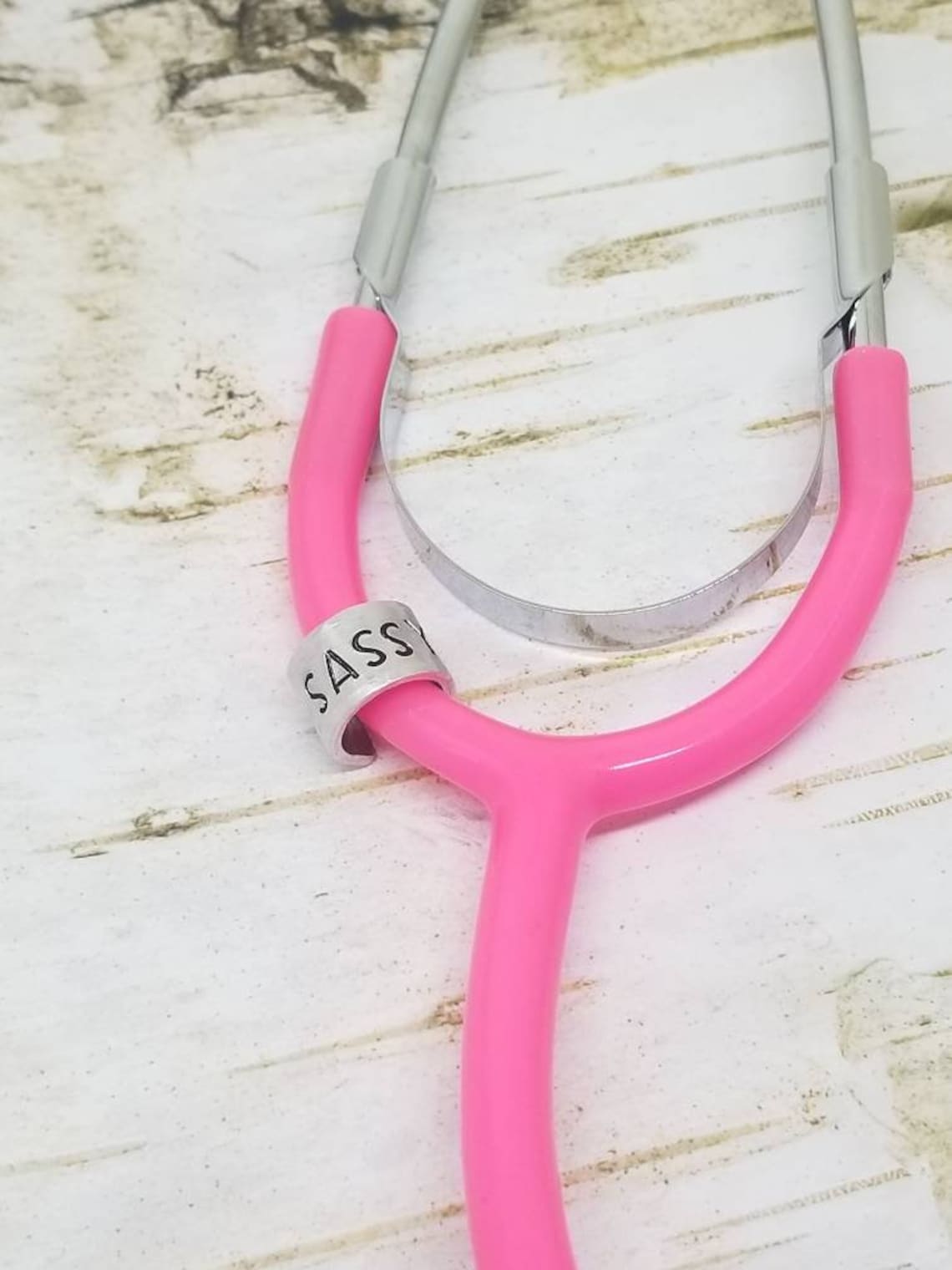 Pink Stethoscope with a metal, stamped tag.