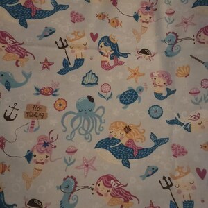 May include: Light blue fabric with a repeating pattern of mermaids, whales, octopuses, starfish, and fish. The mermaids have pink, blonde, and blue hair. The text "No Fishing" is also present in the design.