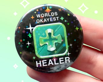 Worlds okayest healer DPS FFXIV inspired sparkly pin back button 44mm badge | MMO rpg game meme quote | Holographic | Fantasy aesthetic