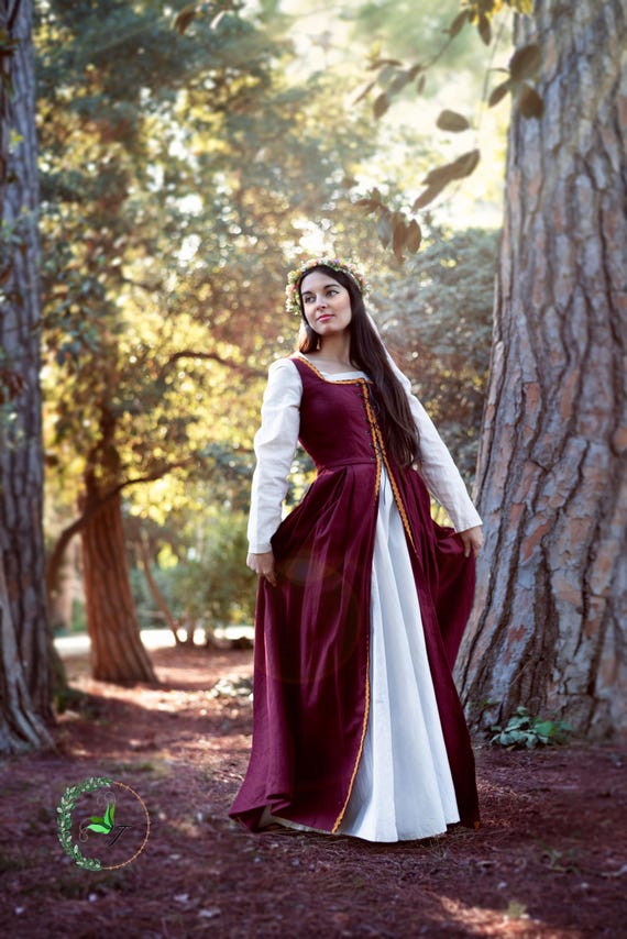 medieval linen dress Women's Hooded Folk Of The Wood boasts an intricate design featuring wide shoulder straps adorned with metal eyelets and adjustable leather lacing Short sleeve medieval linen dress