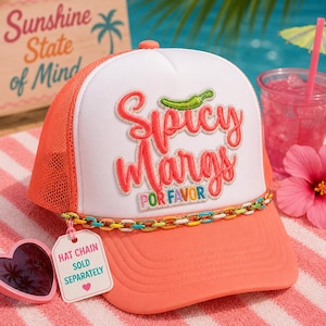 May include: A white and coral trucker hat featuring an embroidered patch that reads Spicy Margs POR FAVOR with a green chili pepper icon. The hat includes a colorful metallic chain across the brim and a white tag that reads HAT CHAIN SOLD SEPARATELY.