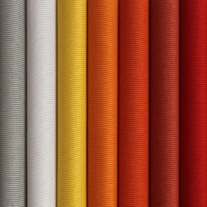 May include: Close-up of eight fabric rolls in various shades of red, orange, yellow, white, and gray. The fabric has a corduroy texture.