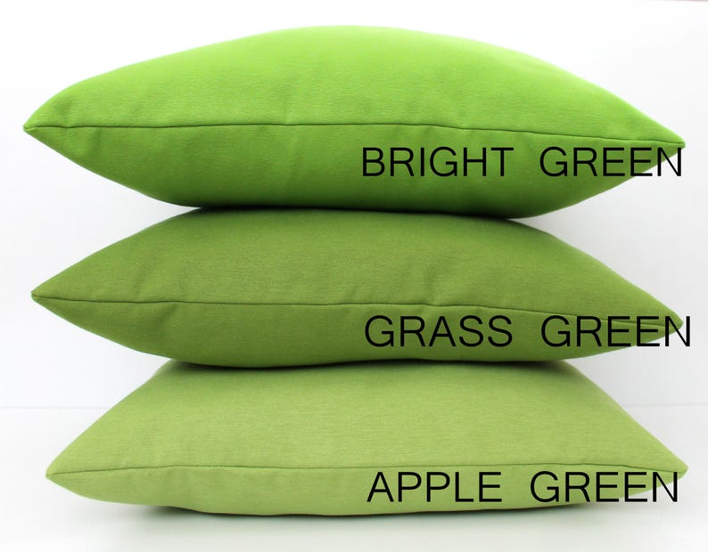May include: Three green cushions stacked. The top cushion is bright green, the middle is grass green, and the bottom is apple green. Text on the image labels each cushion's colour.
