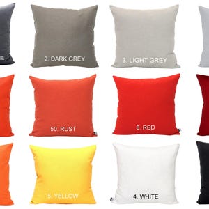 May include: A selection of square cushions in a range of solid colours: charcoal blue, dark grey, light grey, ice grey, orange, rust, red, maroon, tangerine, yellow, white, and black. Each cushion is labelled with a number.
