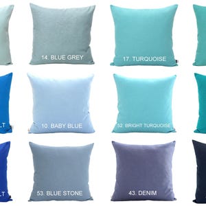 May include: A collection of square throw pillows in various shades of blue and teal. Each pillow is a solid color, with labels indicating the color names such as "Aqua", "Blue Grey", "Turquoise", and "Navy Blue".