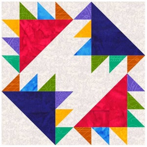 Puede incluir: Un bloque de colcha con un diseño geométrico que presenta un patrón repetitivo de triángulos en tonos de rojo, azul, verde, amarillo y morado.