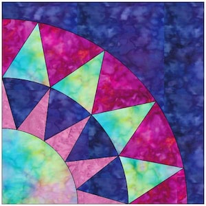 May include: A colorful quilt block with a starburst design. The block is made up of triangles in shades of pink, blue, and green.