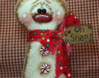 Può includere: Ornamento a forma di pupazzo di neve fatto a mano con un design cucito. L'ornamento presenta un fiocco a pois rossi, bottoni di caramelle e un'etichetta con la scritta "Oh Snap!". Il pupazzo di neve ha guance rosee e una bocca cucita.