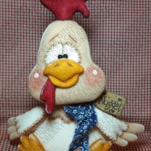 May include: A handmade stuffed chicken with a red comb, yellow beak, and blue bandana. The chicken has stitched details and a tag that says "Nugget". The background is a red and white checkered pattern.