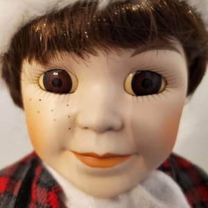 Vintage Anco Porcelain Boy Doll in Winter outfit.