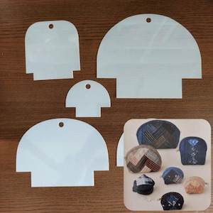May include: A collection of white plastic sewing templates in various sizes, each with a rounded top and a rectangular base. A small hole is at the top of each template. A color image of finished coin purses is in the lower right corner.