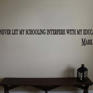 May include: A wall quote with the text "I HAVE NEVER LET MY SCHOOLING INTERFERE WITH MY EDUCATION." attributed to Mark Twain. A wooden bench and a lantern are in the foreground.