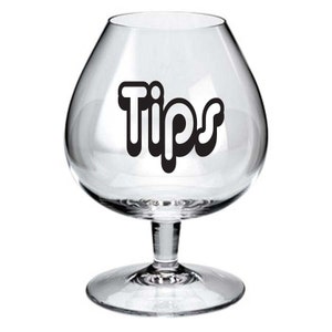 May include: A clear glass goblet with a wide bowl and a stem. The word "Tips" is printed in black on the side of the glass.