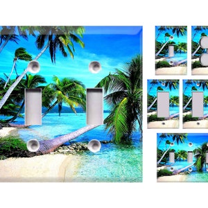 May include: A set of light switch covers featuring a tropical beach scene with palm trees, turquoise water, and white sand. The covers are available in various sizes and configurations, including single, double, and triple.