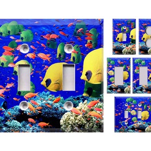 May include: A set of light switch and outlet covers featuring a colorful underwater scene with tropical fish, coral, and a blue background.