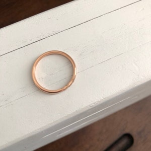 Peut inclure: Une simple bague en or rose. La bague est lisse et a une finition polie.