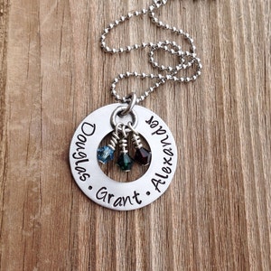May include: Silver necklace with a round pendant engraved with the names "Douglas", "Grant", and "Alexander". Three small beads hang from the pendant.