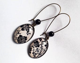 Hanging, bronze earrings, cabochons ovals, black flowers on beige bottom, black pearls.