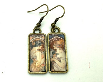 Dangling, mismatched earrings, rectangular cabochons, art nouveau illustration by Alphonse Mucha.