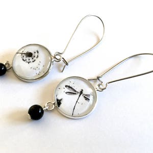 Dangling earrings, dandelion and dragonfly cabochons, black and white, silver metal, black pearls.